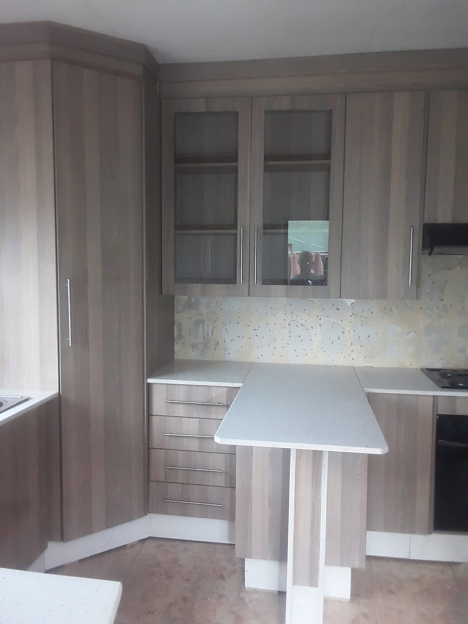 Grey wood-grain kitchen units with display cabinets