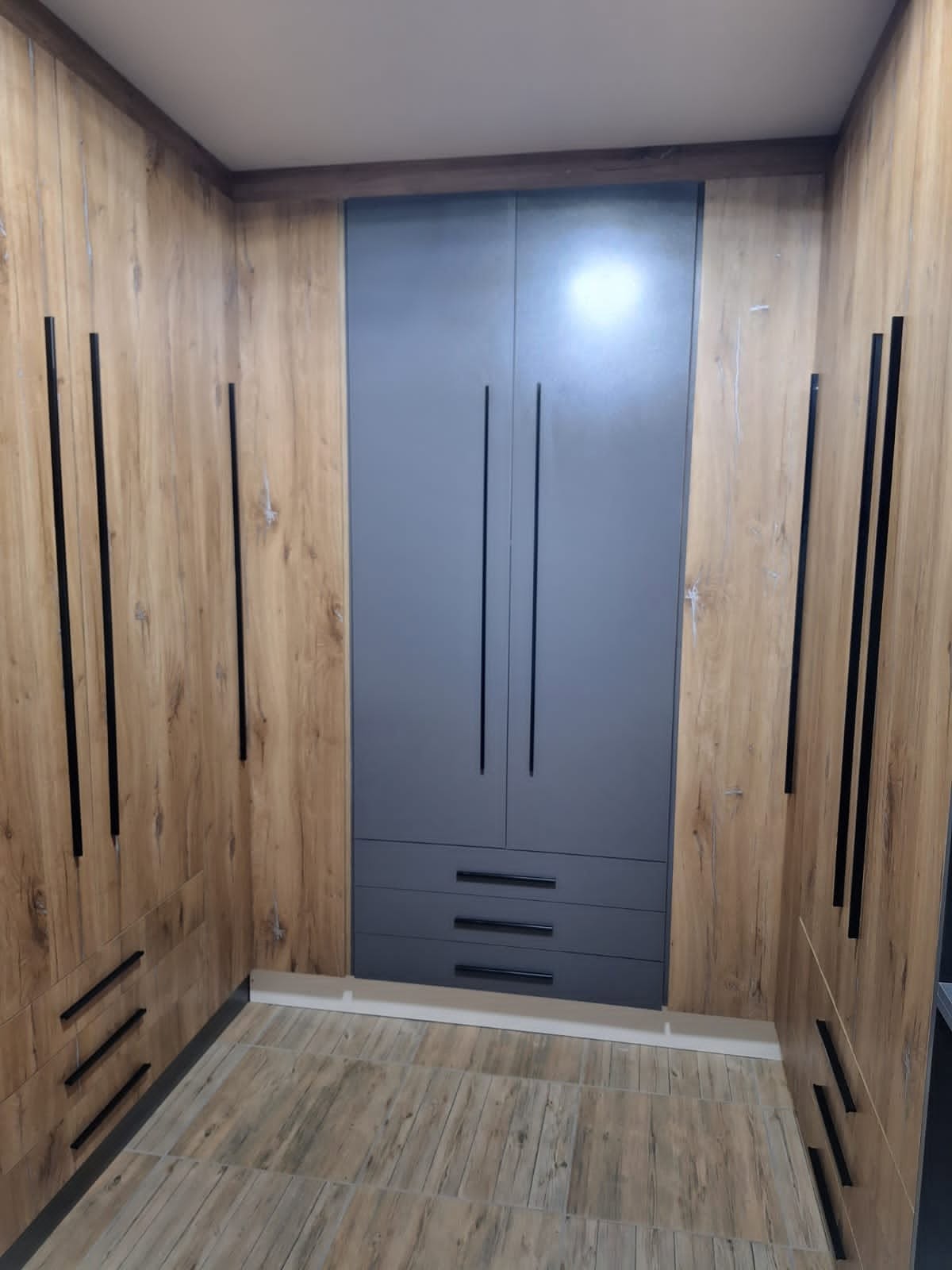 Built-in wardrobe finished in oak and charcoal by PZN Designs