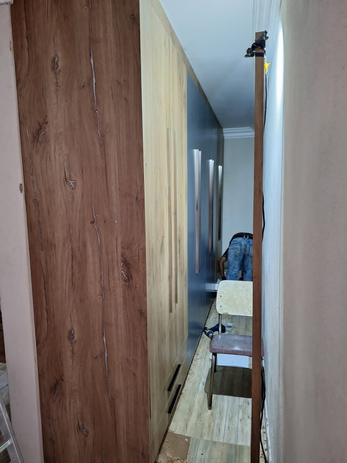 PZN Designs fitter installing built-in cupboards