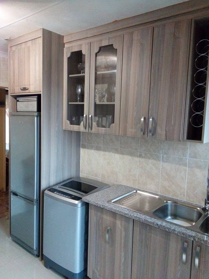 Custom kitchen with glass display cupboards and wine storage by PZN Designs